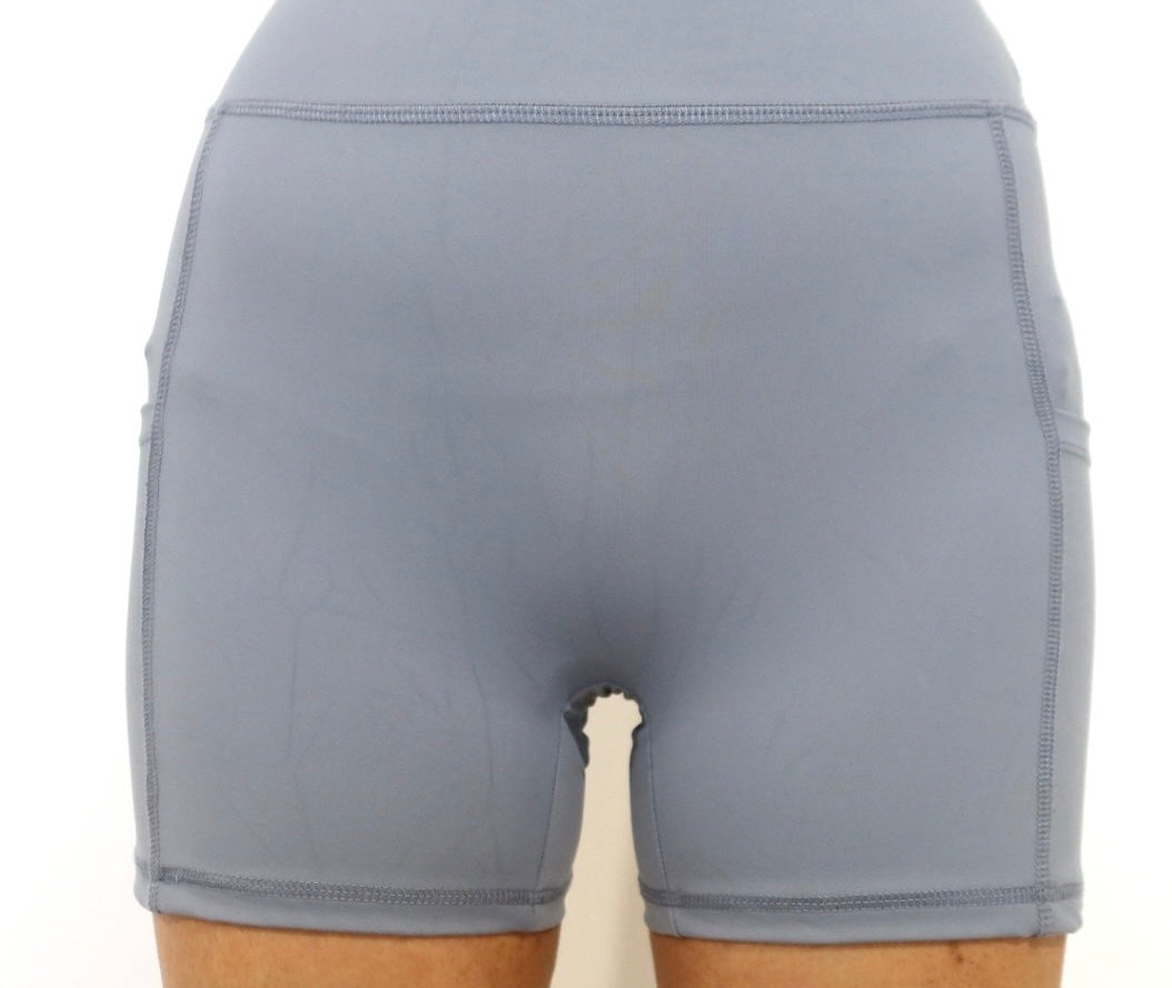 Grey athletic shorts using a cameltoe concealer on a white background